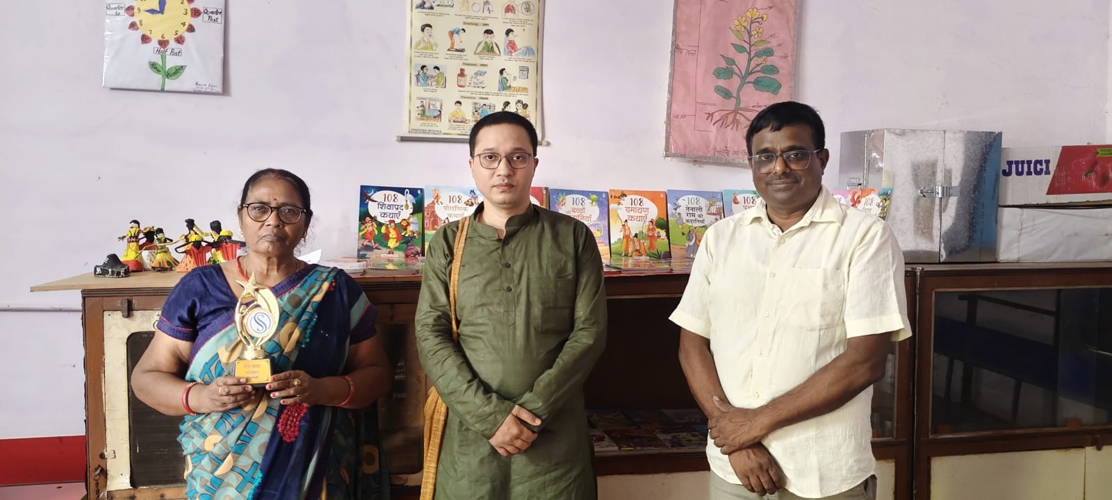SSF team members at a school library with a memento