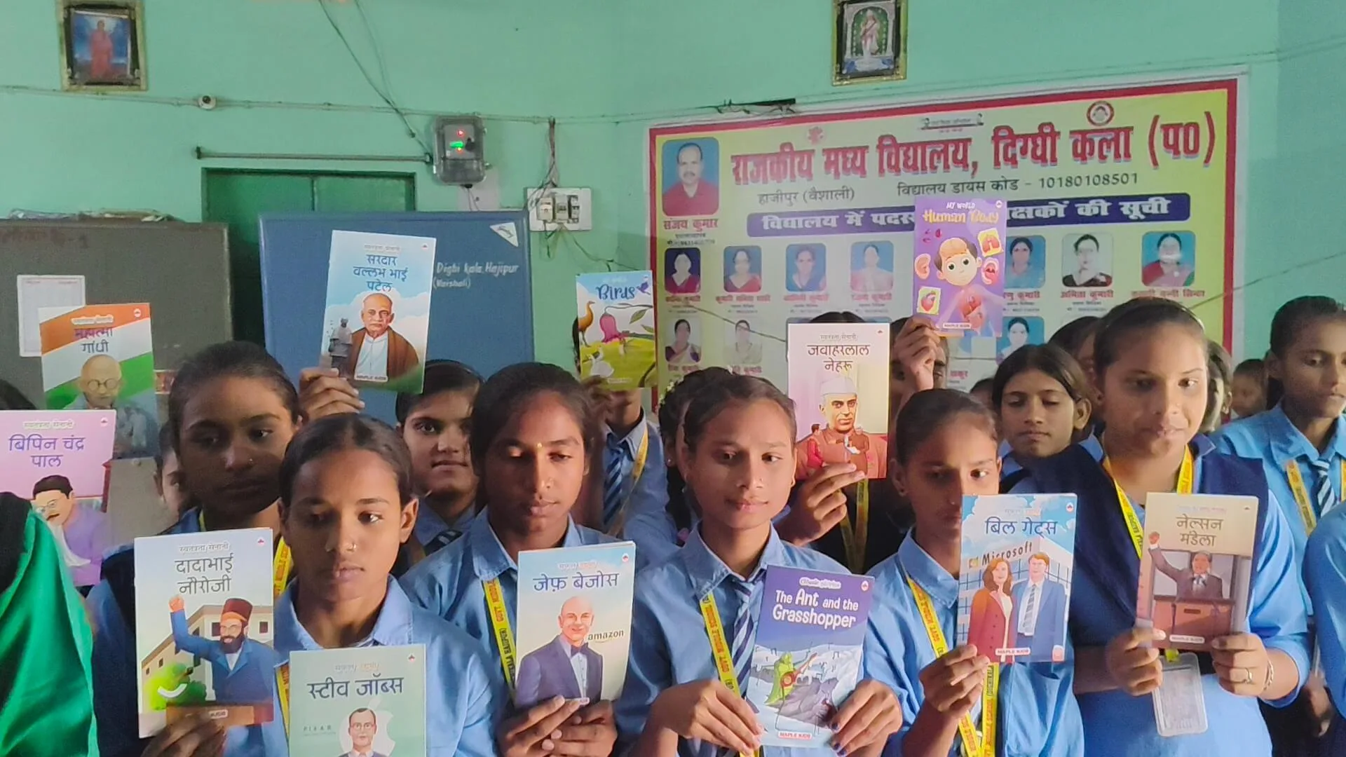 Girl students holding storybooks at an SSF Library in a government school.