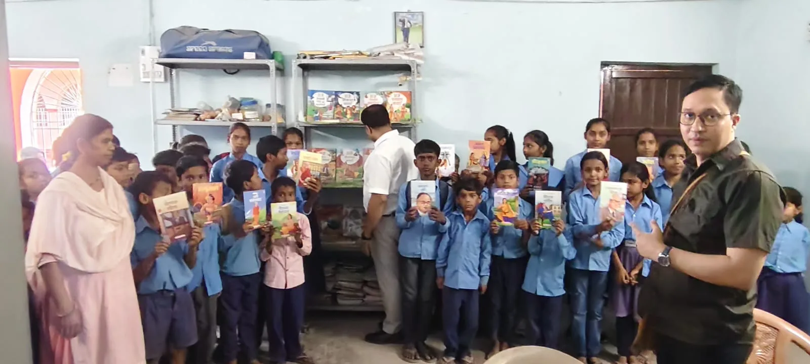 Students holding books during the Shail-Satya Foundation school library inauguration and book distribution program in Saifpur Hajipur.