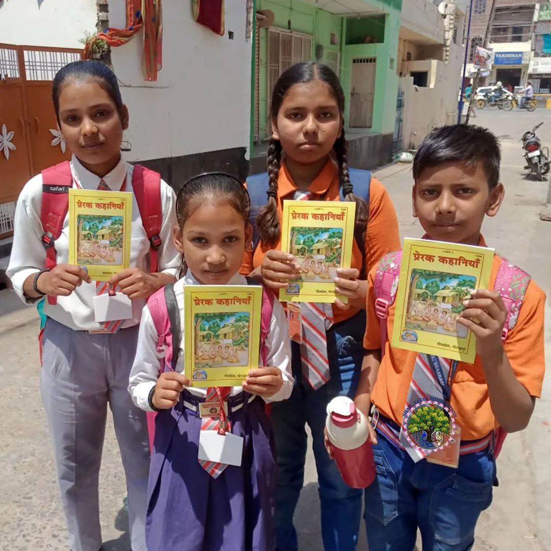 Four children holding Prerak Kahaniya on a Varanasi street