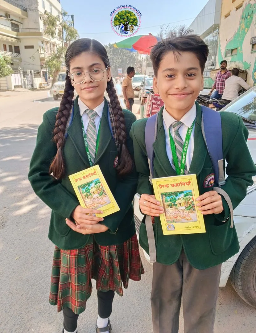 Two students in green blazers with their copies of the book