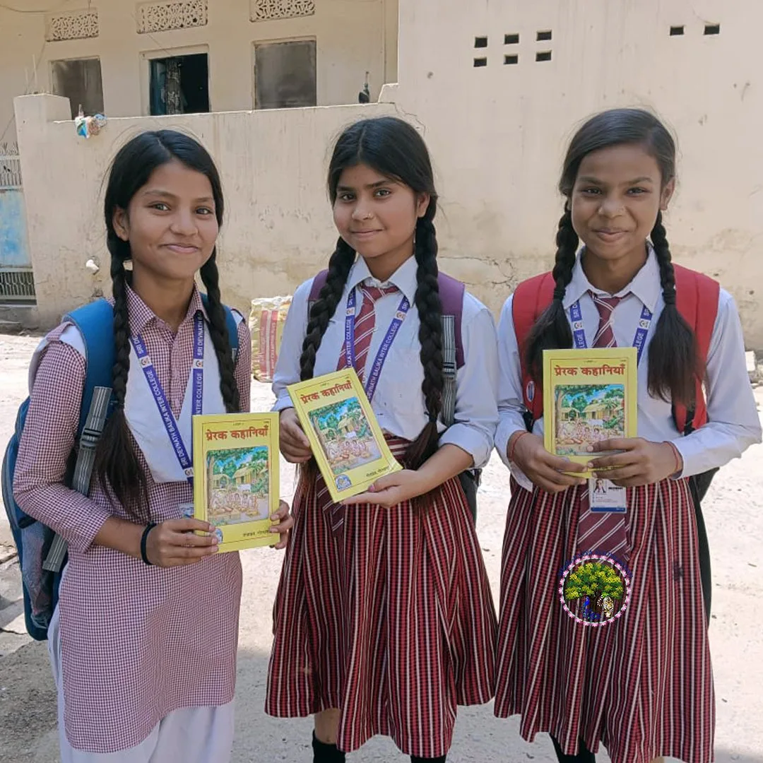 Three girls in school uniform smiling with the book